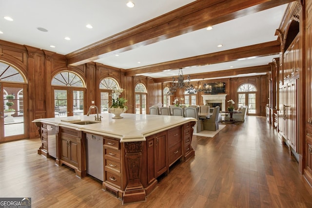 0 Winterthur, Sandy Springs, GA 30328 - kitchen featuring a sink, stainless steel dishwasher, a fireplace, light countertops, and beam ceiling