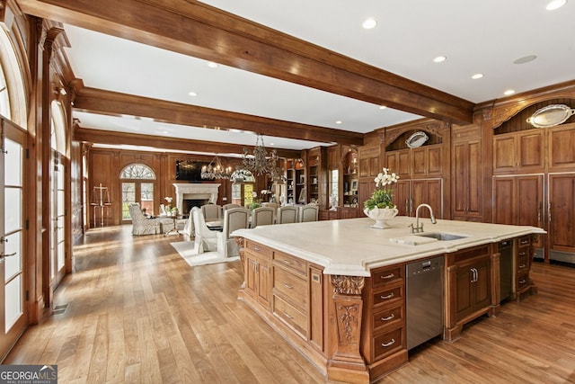 0 Winterthur, Sandy Springs, GA 30328 - kitchen featuring a sink, light wood finished floors, a chandelier, a large island with sink, and beamed ceiling