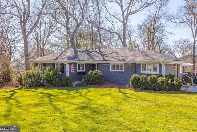 view of front of property with a chimney and a front lawn