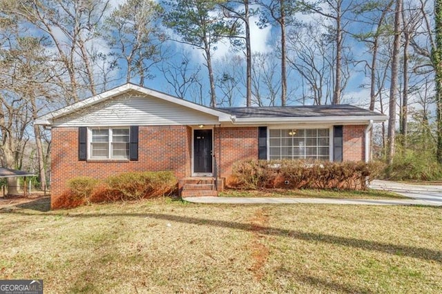 ranch-style house featuring brick siding and a front yard