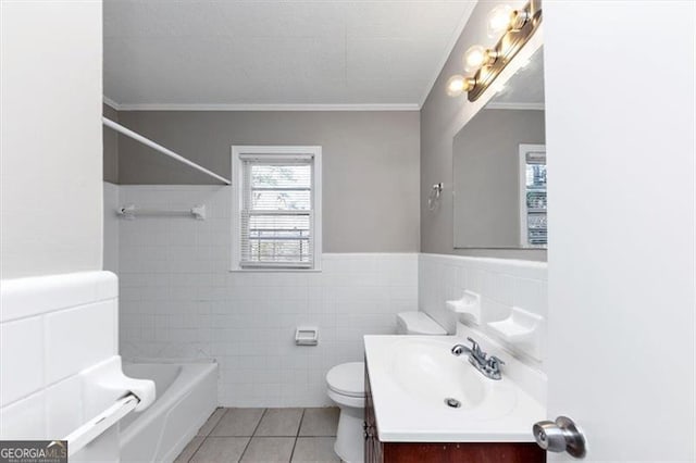 bathroom featuring vanity, ornamental molding, tile patterned floors, toilet, and tile walls