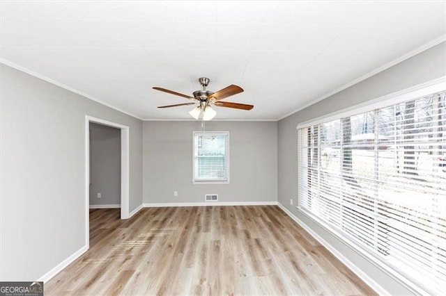 spare room with light wood-style flooring, baseboards, ceiling fan, and ornamental molding