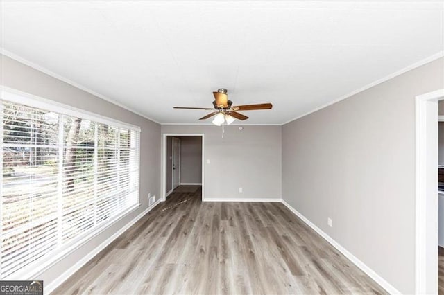 empty room with baseboards, light wood-style floors, ceiling fan, and ornamental molding