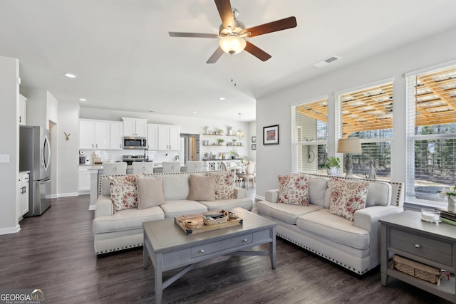 living area featuring visible vents, recessed lighting, dark wood-type flooring, and a ceiling fan