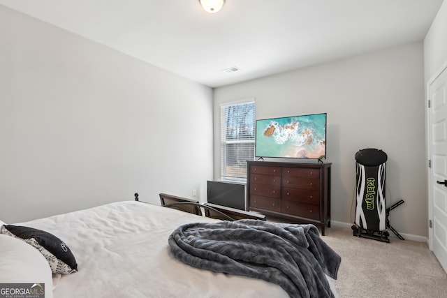 bedroom featuring visible vents, baseboards, and carpet floors