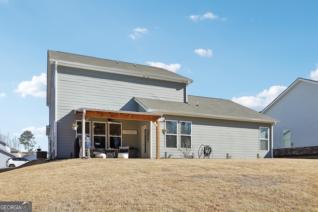 back of property featuring a lawn, central AC, and a ceiling fan