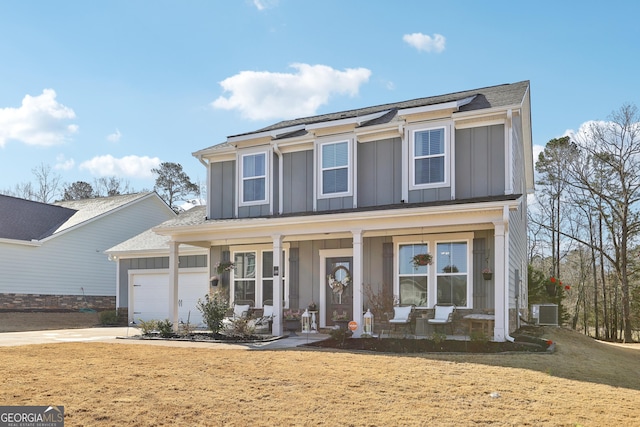 view of front of house featuring central air condition unit, driveway, a porch, board and batten siding, and a front yard