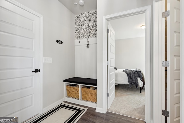 mudroom featuring dark wood-style floors and baseboards