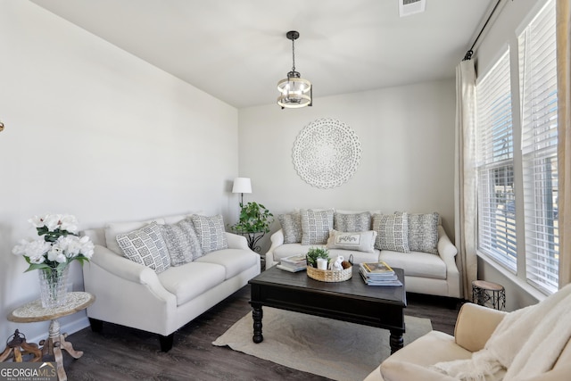 living area with visible vents and wood finished floors