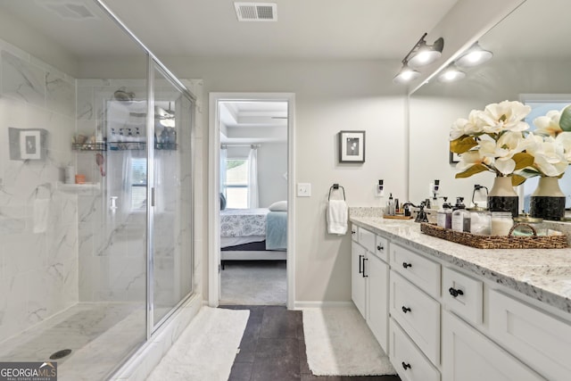 full bath with visible vents, a shower stall, vanity, and connected bathroom