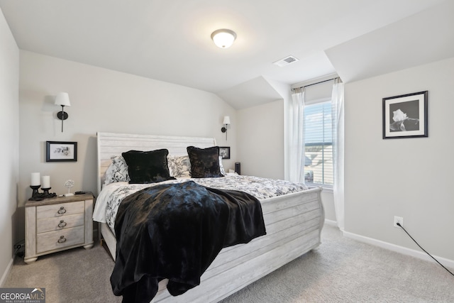 carpeted bedroom featuring vaulted ceiling, baseboards, and visible vents