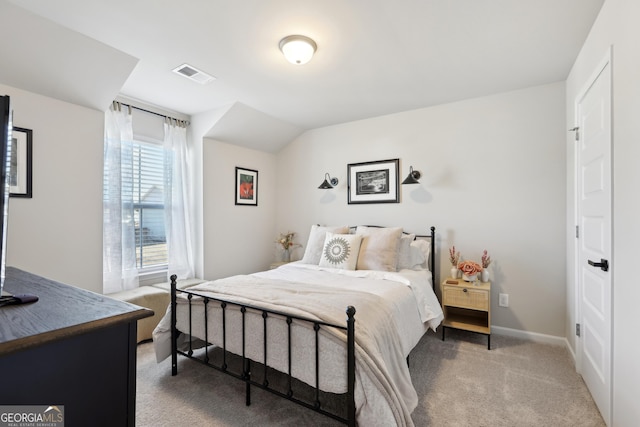 bedroom featuring visible vents, baseboards, and light colored carpet