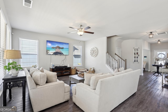 living area with visible vents, a healthy amount of sunlight, and stairway