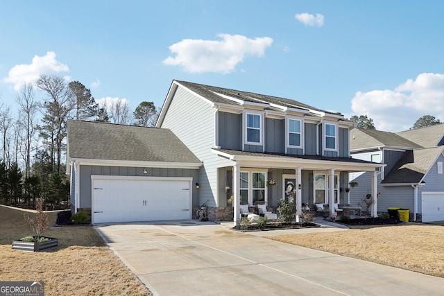 view of front of home featuring driveway, a porch, an attached garage, stone siding, and board and batten siding