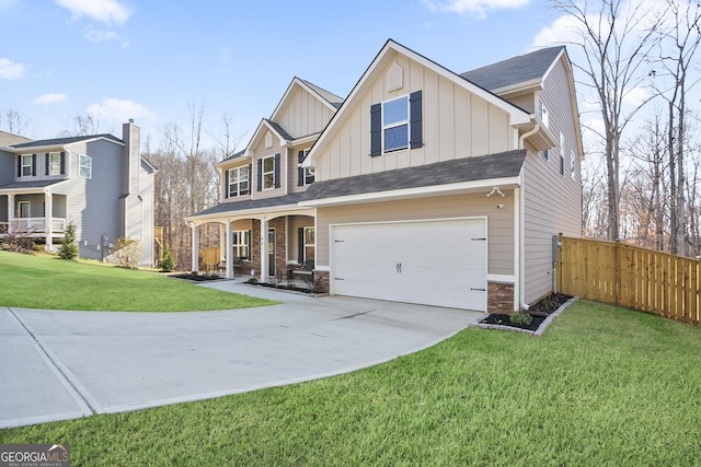 view of front of house featuring board and batten siding, fence, a front yard, a garage, and driveway