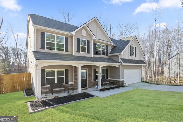 craftsman inspired home featuring fence, driveway, covered porch, a front lawn, and a garage