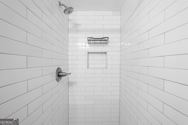bathroom with tiled shower