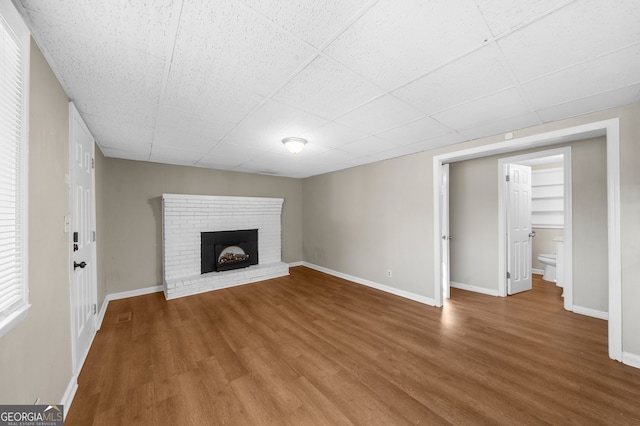 unfurnished living room with wood finished floors and baseboards