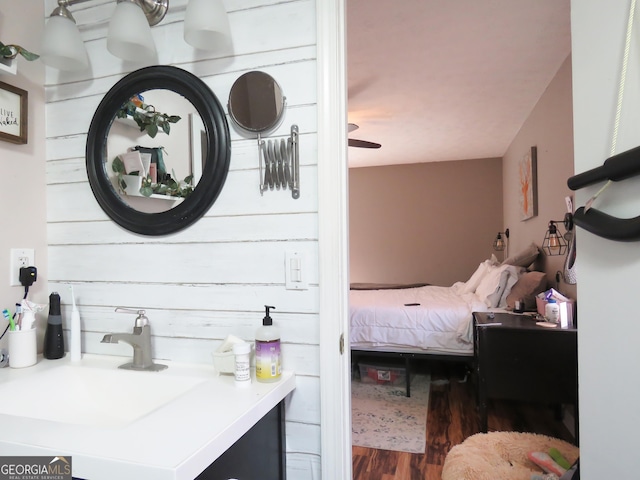 bedroom featuring a sink and wood finished floors