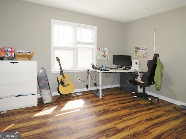 home office with visible vents, baseboards, and wood finished floors