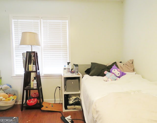 bedroom featuring wood finished floors and baseboards