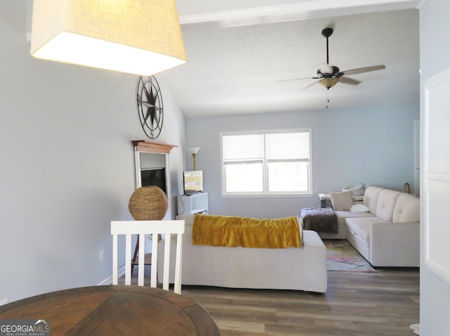 living area featuring vaulted ceiling, wood finished floors, and ceiling fan