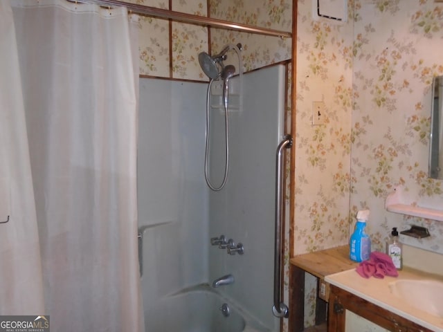 bathroom featuring shower / bath combo, vanity, and wallpapered walls