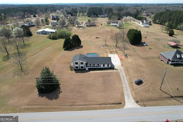 birds eye view of property with a rural view