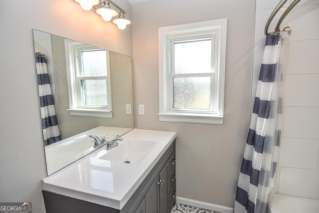 bathroom featuring baseboards and vanity