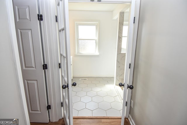 corridor featuring baseboards