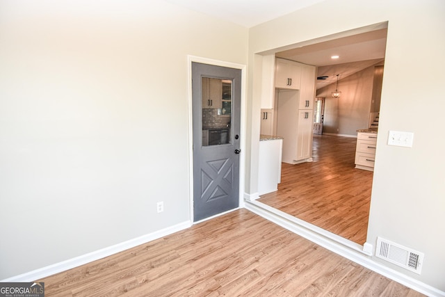 interior space with visible vents, baseboards, and light wood finished floors