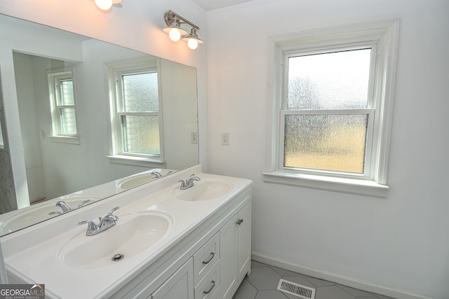 bathroom featuring visible vents and a sink