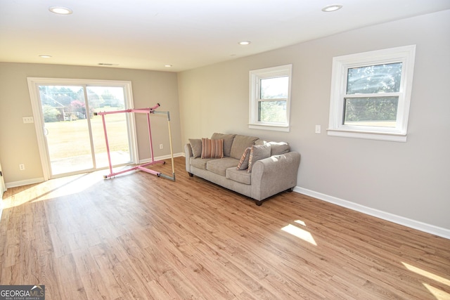 living room featuring recessed lighting, visible vents, baseboards, and wood finished floors