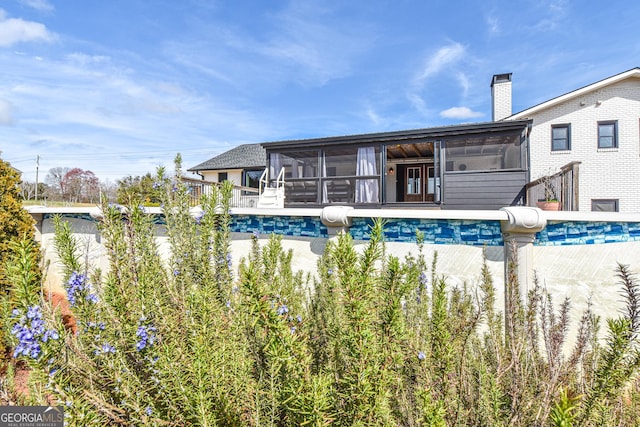 pool featuring a sunroom