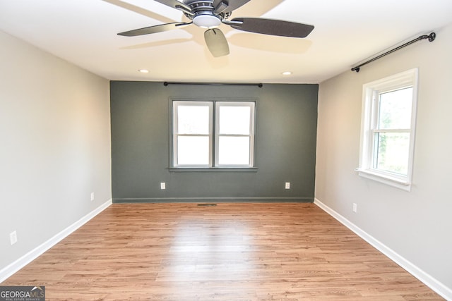 empty room featuring a ceiling fan, recessed lighting, light wood-style floors, and baseboards