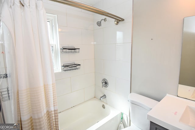 bathroom featuring toilet, vanity, and shower / tub combo