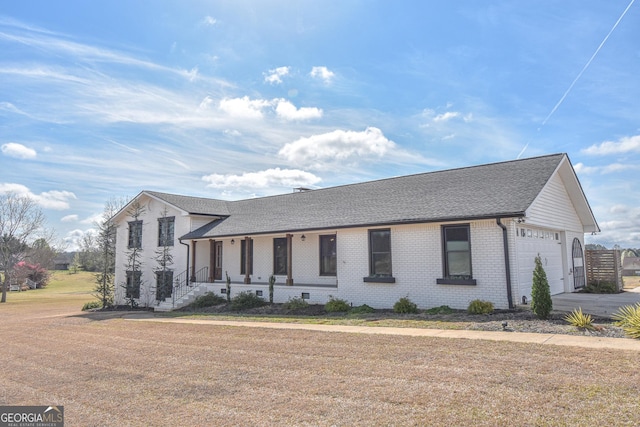 view of front of house with concrete driveway, brick siding, a garage, and a shingled roof