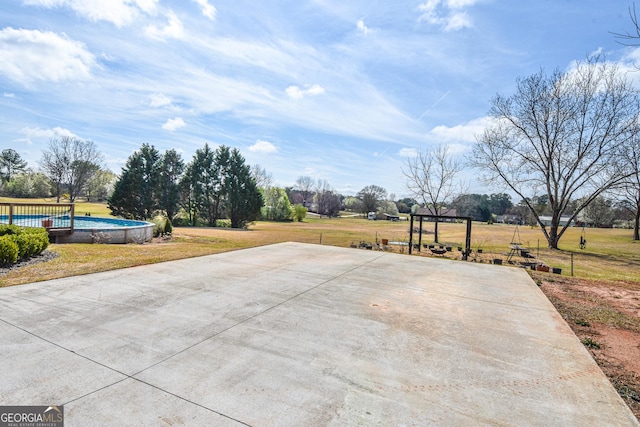 view of patio featuring an outdoor pool and community basketball court