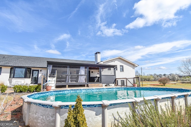 outdoor pool featuring a sunroom