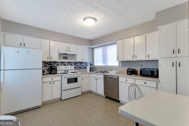 kitchen featuring under cabinet range hood, light countertops, white cabinets, white appliances, and a sink