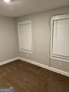 spare room featuring baseboards