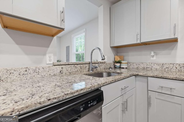 kitchen featuring a sink, light stone countertops, dishwasher, and white cabinets