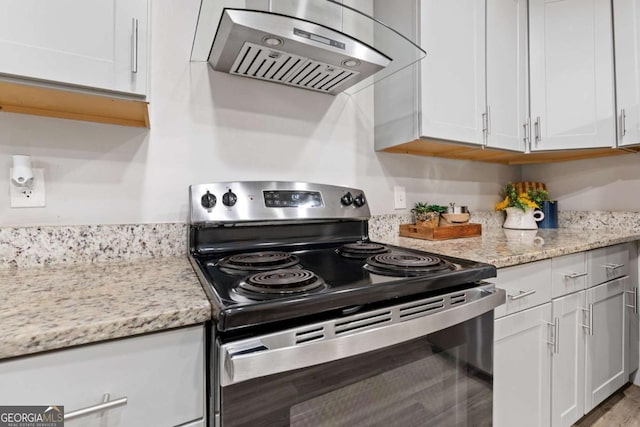 kitchen featuring range hood, white cabinetry, electric stove, and light stone countertops