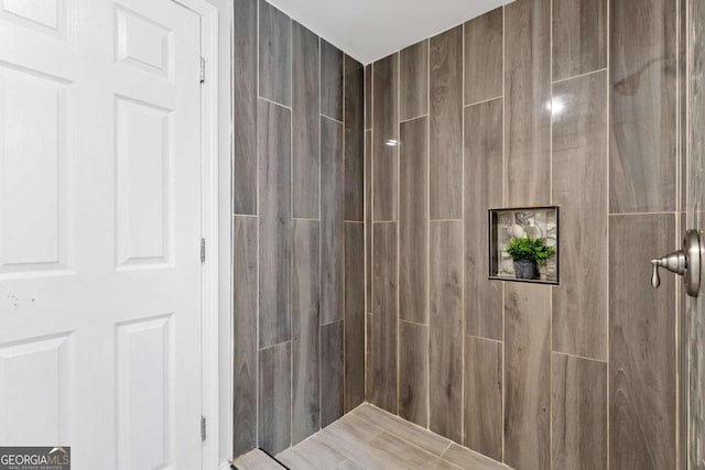 bathroom with tiled shower