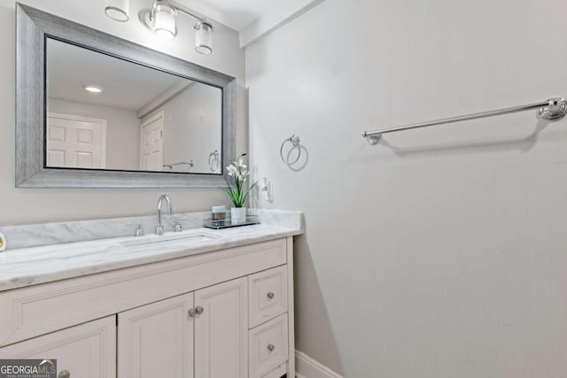 bathroom featuring baseboards and vanity