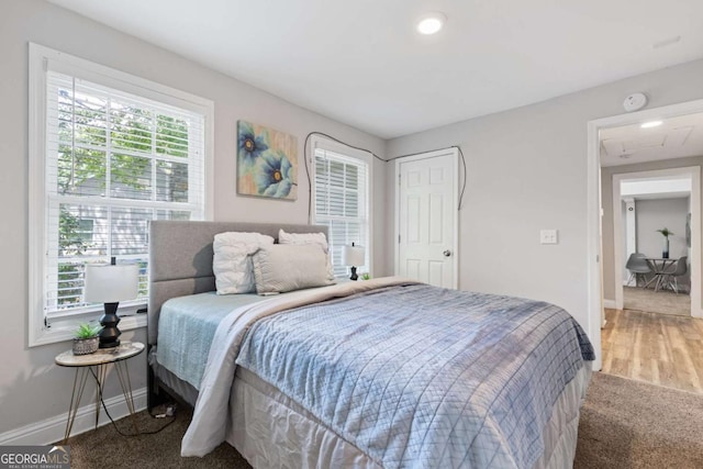 bedroom with baseboards and wood finished floors