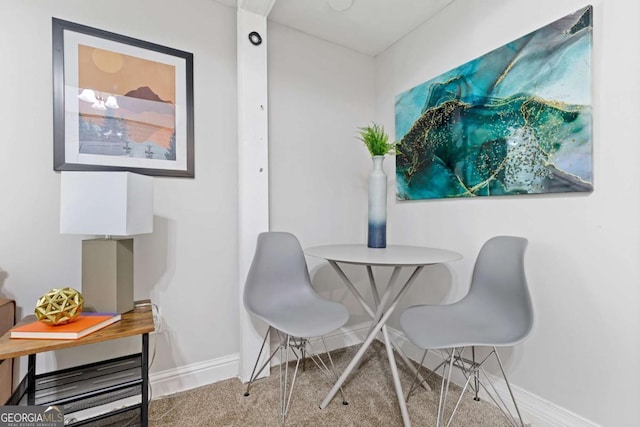 dining area featuring baseboards and carpet floors