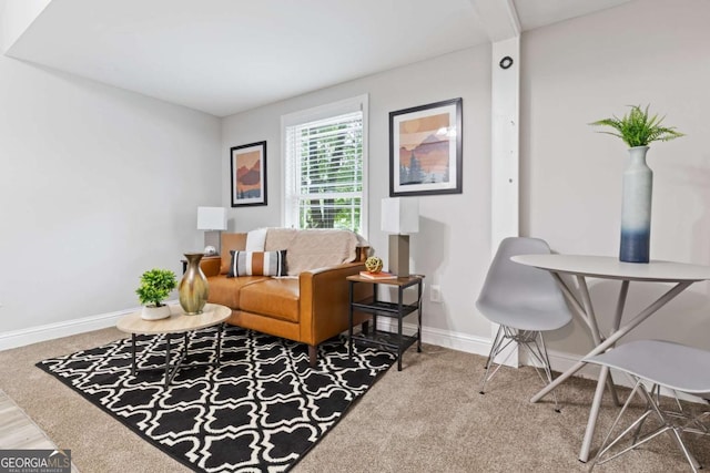 carpeted living room featuring baseboards