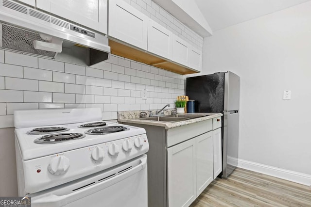 kitchen with tasteful backsplash, under cabinet range hood, white range with electric cooktop, light wood-type flooring, and a sink