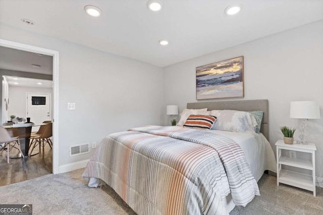 carpeted bedroom featuring recessed lighting, visible vents, and baseboards